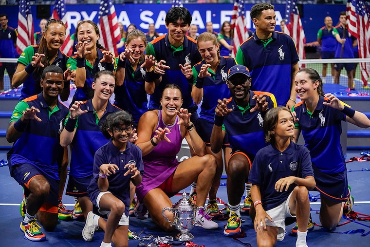 Tournament champion Belarus"s Aryna Sabalenka poses with the ball crew after the women"s final match on day thirteen of the US Open tennis tournament at the USTA Billie Jean King National Tennis Center in New York City, on September 7, 2024.
