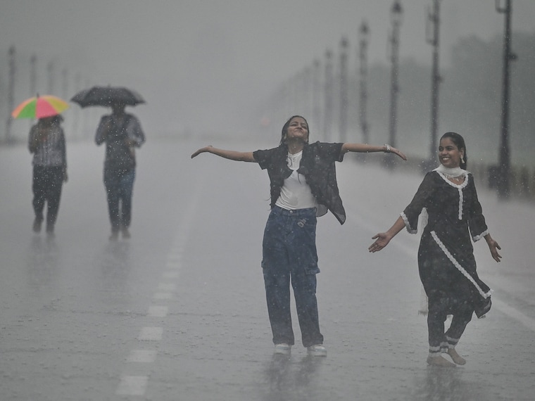 Young strollers enjoy the incessant rainfall at Kartavya Path near India Gate, on September 13, 2024 in New Delhi, India. While a massive downpour caused traffic disruptions in Delhi-NCR, the city exceeded its annual and seasonal average rainfall in the early days of September, and enjoyed the cleanest air of the year. Image: Raj K Raj/HT via Getty Images