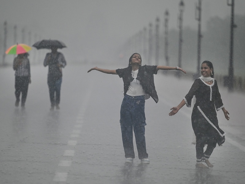 Young strollers enjoy the incessant rainfall at Kartavya Path near India Gate, on September 13, 2024 in New Delhi, India. While a massive downpour caused traffic disruptions in Delhi-NCR, the city exceeded its annual and seasonal average rainfall in the early days of September, and enjoyed the cleanest air of the year. Image: Raj K Raj/HT via Getty Images