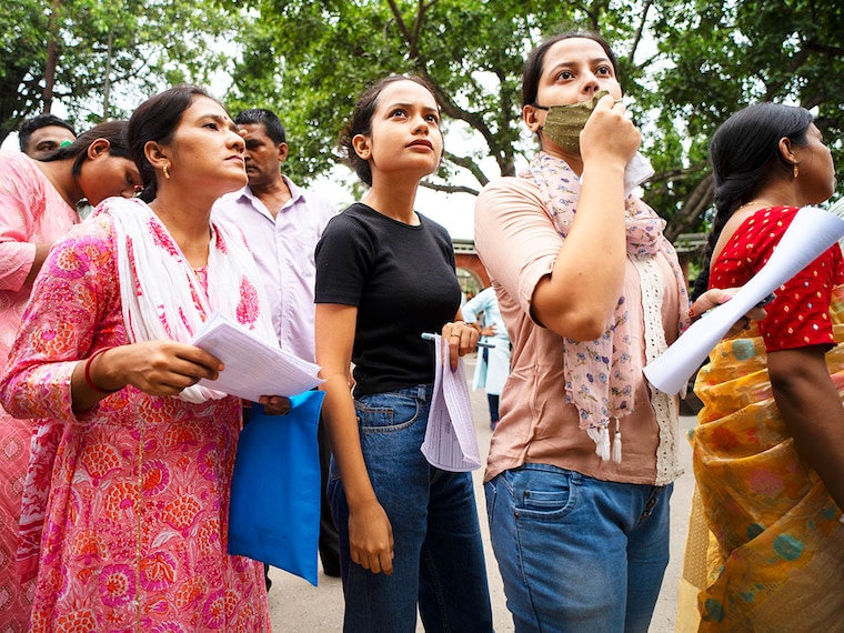Job aspirants seeking Grade III jobs in the Assam government wait in line to enter an examination centre in Guwahati on September 15, 2024. Over a million candidates appeared in a written examination to fill vacant Group III posts in the Assam government amid tight security arrangements and suspension of mobile internet services across the state.