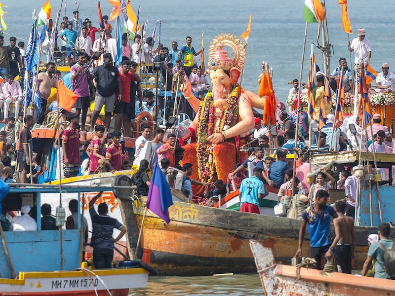 Devotees take Ganpati idol of Lalbaugcha Raja for immersion, at Girgaon chowpatty on September 18, 2024 in Mumbai, India.