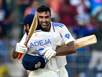 India"s Ravichandran Ashwin celebrates with his teammate Ravindra Jadeja after scoring a century during the first day of the first Test cricket match between India and Bangladesh at the MA Chidambaram Stadium in Chennai on September 19, 2024.