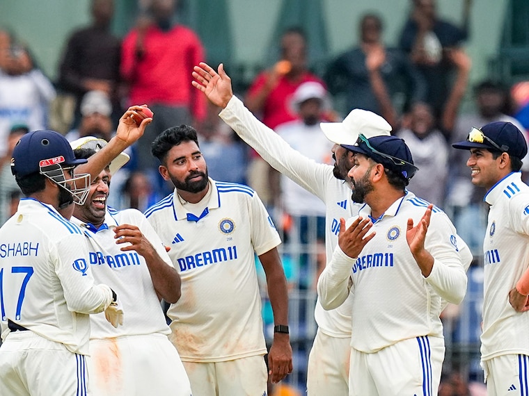 India"s Ravichandran Ashwin, with teammates, shows the ball after taking 5 wickets on the fourth day of the first Test cricket match between India and Bangladesh at MA Chidambaram Stadium, in Chennai, Sunday, September 22, 2024. India won the first Test match of the series by 280 runs.