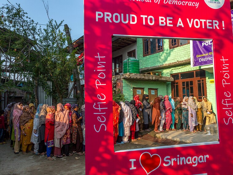Kashmiri women wait in a queue before casting their votes during the second phase of voting in the assembly elections on 25 September 2024 in Srinagar. Polling began yesterday in 26 constituencies of Jammu and Kashmir for the second phase of assembly elections, under heavy security. Over 2.5 million voters are set to decide the fate of 239 candidates from six districts. Diplomats from 16 countries, including the US and Singapore, are observing the process. Despite security concerns, voter turnout has been strong. The third phase is scheduled for October 1, with results expected on October 8.