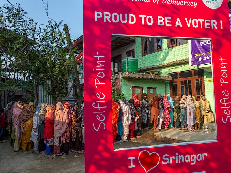 Kashmiri women wait in a queue before casting their votes during the second phase of voting in the assembly elections on 25 September 2024 in Srinagar. Polling began yesterday in 26 constituencies of Jammu and Kashmir for the second phase of assembly elections, under heavy security. Over 2.5 million voters are set to decide the fate of 239 candidates from six districts. Diplomats from 16 countries, including the US and Singapore, are observing the process. Despite security concerns, voter turnout has been strong. The third phase is scheduled for October 1, with results expected on October 8.