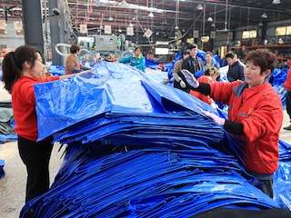 Employees check woven plastic bags at a factory which produces plastic products for export in Lianyungang, in China’s eastern Jiangsu province on March 10, 2025. Image: AFP  / China OUT