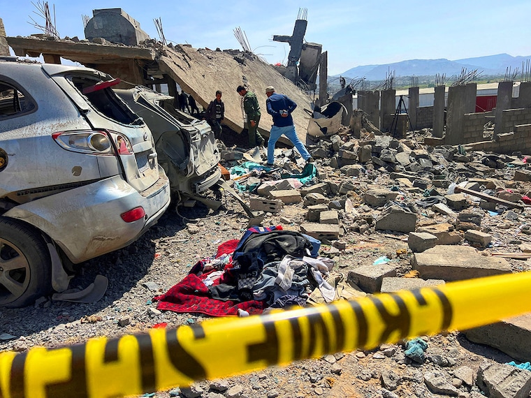 People inspect the site of a US airstrike in Sanaa, Yemen, on April 7, 2025. According to the Houthi-run Al-Masirah TV, the strike took place in the Shaab Al-Hafa neighbourhood in the Shu"ub district in the capital and killed 4 Yemenis and injured dozens. The US has been conducting its biggest military attacks against the Yemeni group under President Donald Trump"s administration since March 15.