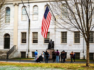 People gather around the John Harvard Statue on the Harvard University campus in Cambridge, Massachussetts, on April 15, 2025. Elite US university Harvard was hit with a $2.2 billion federal funding freeze on April 14 after rejecting a list of sweeping demands that the White House said was intended to crack down on campus anti-Semitism.
Image:  Joseph Prezioso / AFP