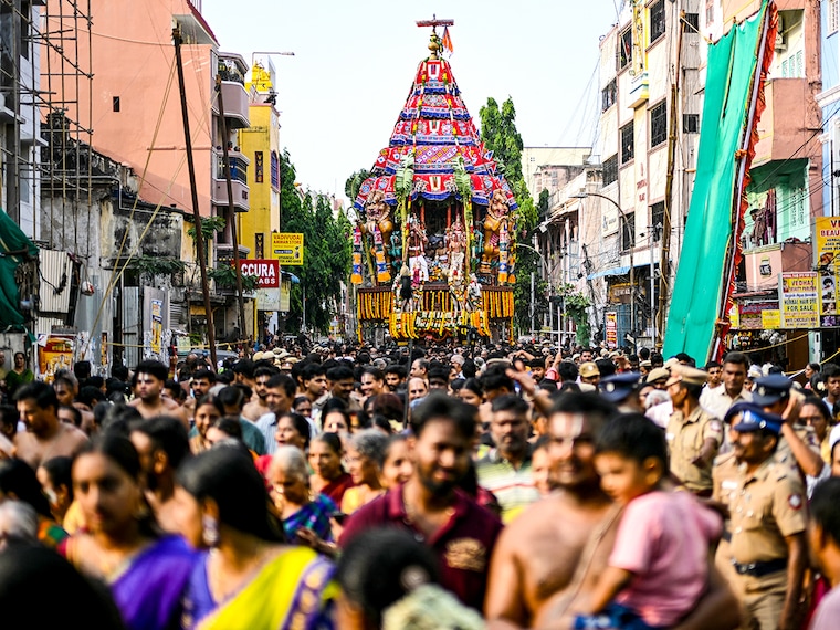Hindu devotees take part in a religious procession to mark the chariot festival of Sri Parthasarthy Swamy temple in Chennai on April 19, 2025.