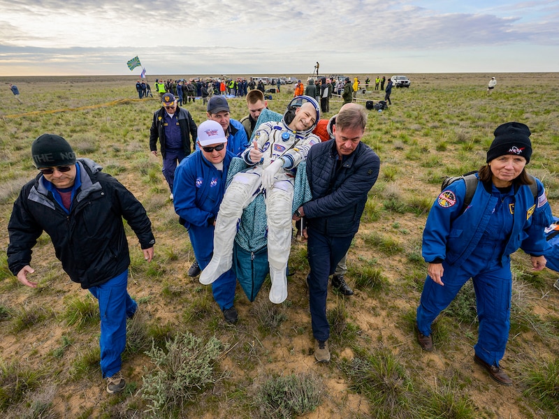 NASA astronaut Don Pettit (C) being carried to a medical tent shortly after he and Roscosmos cosmonauts Alexey Ovchinin and Ivan Vagner landed in their Soyuz MS-26 spacecraft near the town of Zhezkazgan, Kazakhstan on April 20, 2025. The trio are returning to Earth after logging 220 days in space as members of Expeditions 71 and 72 aboard the International Space Station.