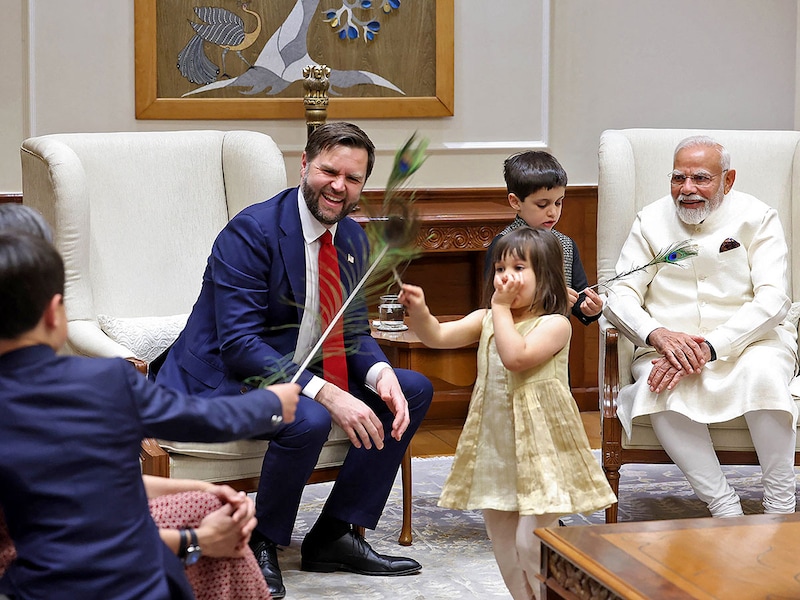 India’s Prime Minister Narendra Modi (right) hosts US Vice President JD Vance (left), wife Usha Vance (back to the camera) and their children Mirabel, Ewan and Vivek at his residence in New Delhi on April 21, 2025. US VP JD Vance met with Indian PM Modi after a red carpet welcome in New Delhi on April 21, as India bids for an early trade deal to stave off punishing tariffs.