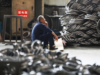 A worker rests in a factory making steel bike rims for export to the U.S. in Hangzhou in east China"s Zhejiang province Friday, April 11, 2025. 
Image: Feature China/Future Publishing via Getty Images