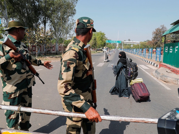 A woman crosses a Border Security Force (BSF) checkpoint at the Attari-Wagah border crossing on the India-Pakistan border, near Amritsar, India, April 25, 2025. India has announced the closure of the Attari border for all movement as part of heightened security measures against Pakistan following the Pahalgam terror attacks. The closure will affect cross-border trade worth Rs 3,800 crore between India and Pakistan.