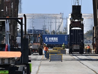 A worker directs truck traffic at a terminal at the Port of Los Angeles, in Los Angeles, California, on July 31, 2025. President Donald Trump ordered the reimposition of tariffs on dozens of trading partners - his cornerstone strategy for reshaping global trade to benefit the US economy.
Image: Robyn Beck / AFP