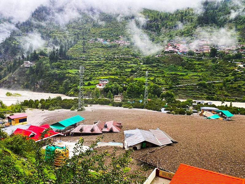 This handout photograph taken on August 5, 2025 and released by the Indian Army shows residential buildings partially submerged in sludge after a cloudburst caused a massive mudslide in India"s Uttarakhand state. A flash flood driving a torrent of mud smashed into a town in India"s Himalayan region on August 5, tearing down a mountain valley before demolishing buildings and killing at least four people.