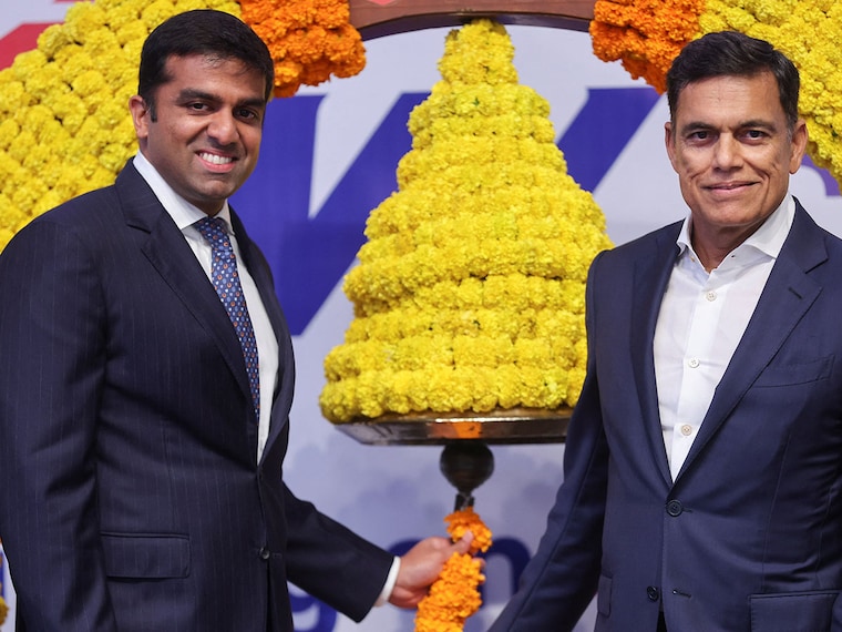 Parth Jindal, managing director of JSW Cement, and his father, Sajjan Jindal, managing director of JSW Steel, pose during the listing ceremony of JSW Cement at the National Stock Exchange (NSE), in Mumbai, India, August 14, 2025.