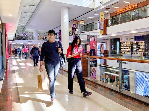 File Photo: Shoppers walk inside a shopping mall in New Delhi. Image: REUTERS/Anushree Fadnavis File Photo: Shoppers walk inside a shopping mall in New Delhi. Image: REUTERS/Anushree Fadnavis