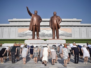 People paying their respects before the statues of late North Korean leaders Kim Il Sung and Kim Jong Il at Mansu Hill
Image: Kim Won Jin / AFPÂ©