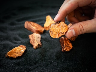 Rare earths are often found in minute ore concentrations, meaning large amounts of rock must be processed to produce the refined product, often in powder form.
Image: Shutterstock