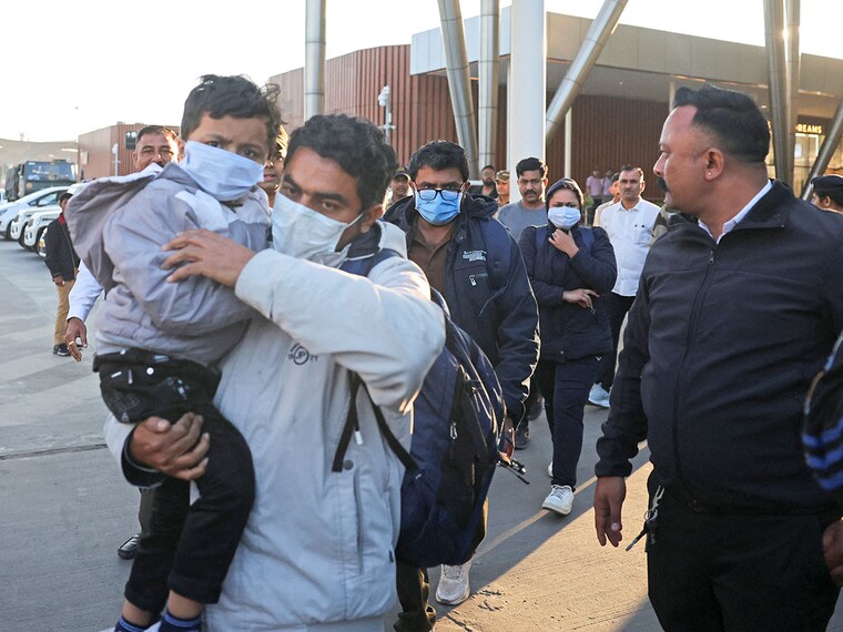 Indian immigrants deported from the US walk out of the airport in Ahmedabad, India on February 6, 2025.