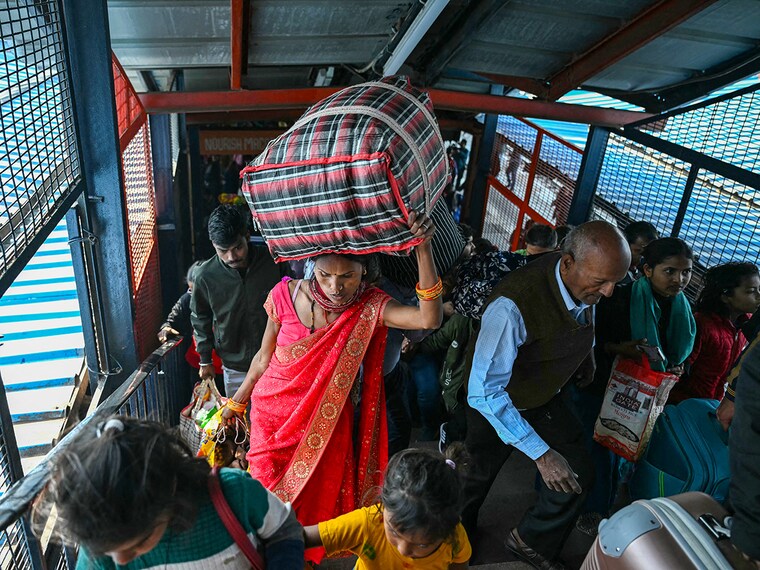 Passengers are pictured at the New Delhi railway station in New Delhi on February 16, 2025. At least 15 people died during a stampede at a railway station in India"s capital late on February 15 when surging crowds scrambled to catch trains to the world"s largest religious gathering at Maha Kumbh Mela, a medical official told AFP.