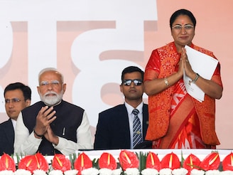 Prime Minister Narendra Modi applauds as Bharatiya Janata Party"s Rekha Gupta greets the audience before taking her oath as the new Chief Minister of Delhi at the Ramlila grounds in New Delhi, India, on February 20, 2025.
