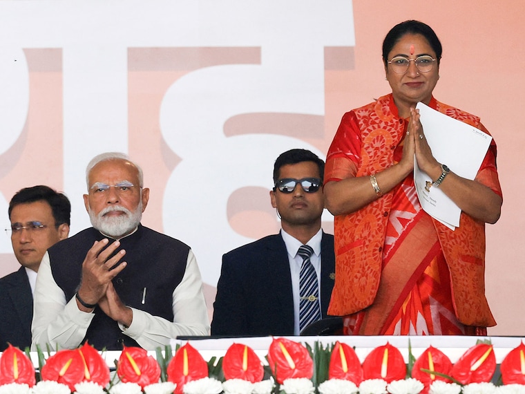 Prime Minister Narendra Modi applauds as Bharatiya Janata Party"s Rekha Gupta greets the audience before taking her oath as the new Chief Minister of Delhi at the Ramlila grounds in New Delhi, India, on February 20, 2025.