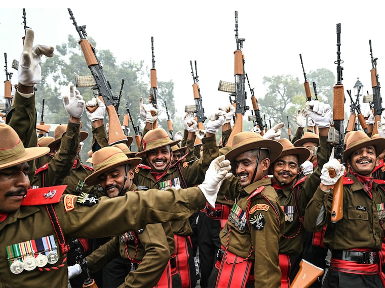 Indian army soldiers dance to the tunes of a military band as they take a break during rehearsals for the upcoming Republic Day parade on a cold winter morning in New Delhi on January 3, 2025.