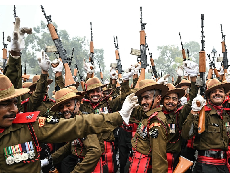 Indian army soldiers dance to the tunes of a military band as they take a break during rehearsals for the upcoming Republic Day parade on a cold winter morning in New Delhi on January 3, 2025.