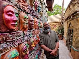 Adel Yazdi, an Iranian artist who has transformed an alley in one of the old neighbourhoods of Shiraz into an open air permanent art gallery, stands next to one of his high reliefs in the central Iranian city.
Image: Atta Kenare / AFP©
