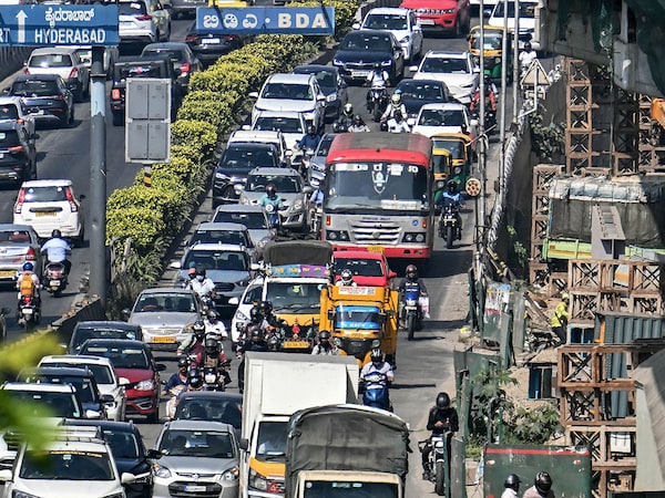 Commuters wait in a traffic jam along a road in Bengaluru on January 6, 2025. 
Image: Idrees Mohammed / AFPÂ©