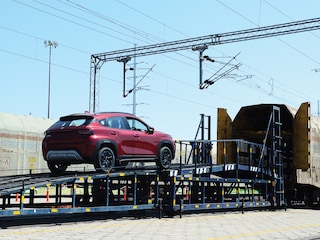 A workers loads a Maruti Suzuki Fronx car model on a train at the Maruti Suzuki Hansalpur plant, some 80 km from Ahmedabad
Image: Sam Panthaky / AFP