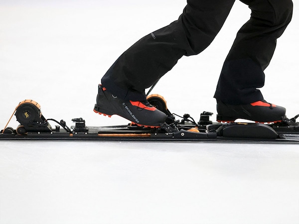 E-SKIMO founder Nicola Colombo demonstrates his company’s electric assisted skis during an E-SKIMO event at Hylo Park Ice Arena. 
Image: Ian Maule / AFPÂ©