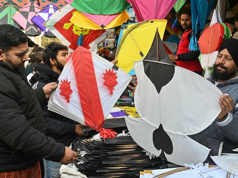 People buy kites on the eve of Lohri festival at a market in Amritsar on January 12, 2025.