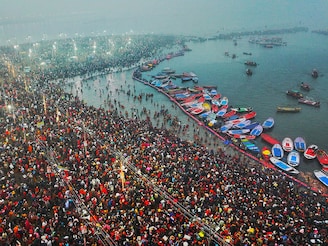 This aerial handout photograph taken and released by Uttar Pradesh State Information Department on January 13, 2025, shows Hindu pilgrims taking a holy dip in the sacred waters of Sangam, the confluence of Ganges, Yamuna and mythical Saraswati rivers, during the Maha Kumbh Mela festival in Prayagraj. Vast crowds of Hindu pilgrims bathed in sacred waters as the Kumbh Mela festival opened on January 13, with organisers expecting 400 million people—the world"s largest gathering of humanity—to assemble over six weeks.