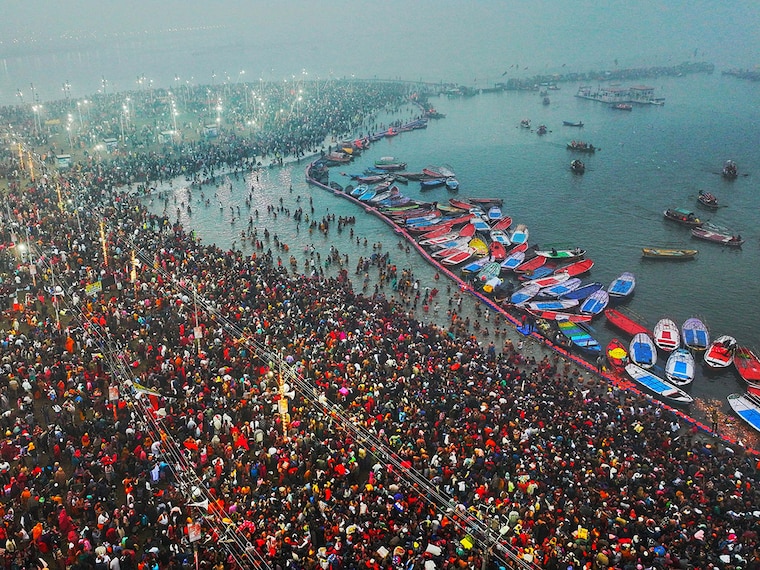 This aerial handout photograph taken and released by Uttar Pradesh State Information Department on January 13, 2025, shows Hindu pilgrims taking a holy dip in the sacred waters of Sangam, the confluence of Ganges, Yamuna and mythical Saraswati rivers, during the Maha Kumbh Mela festival in Prayagraj. Vast crowds of Hindu pilgrims bathed in sacred waters as the Kumbh Mela festival opened on January 13, with organisers expecting 400 million people—the world"s largest gathering of humanity—to assemble over six weeks.
