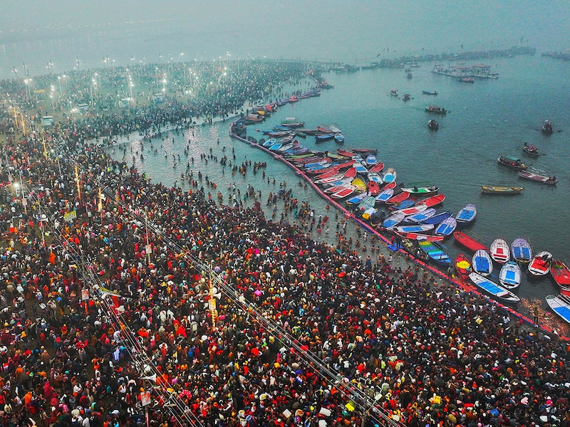 This aerial handout photograph taken and released by Uttar Pradesh State Information Department on January 13, 2025, shows Hindu pilgrims taking a holy dip in the sacred waters of Sangam, the confluence of Ganges, Yamuna and mythical Saraswati rivers, during the Maha Kumbh Mela festival in Prayagraj. Vast crowds of Hindu pilgrims bathed in sacred waters as the Kumbh Mela festival opened on January 13, with organisers expecting 400 million people—the world"s largest gathering of humanity—to assemble over six weeks.