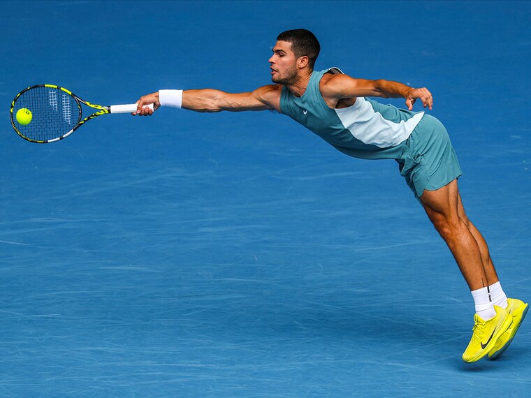 Spain"s Carlos Alcaraz hits a return against Japan"s Yoshihito Nishioka during the men"s singles match on day four of the Australian Open tennis tournament in Melbourne on January 15, 2025.