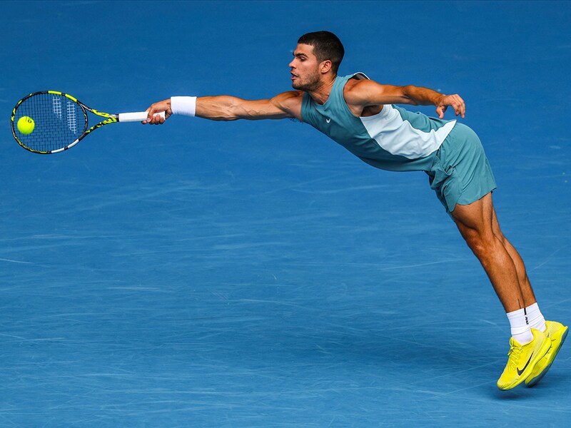 Spain"s Carlos Alcaraz hits a return against Japan"s Yoshihito Nishioka during the men"s singles match on day four of the Australian Open tennis tournament in Melbourne on January 15, 2025.