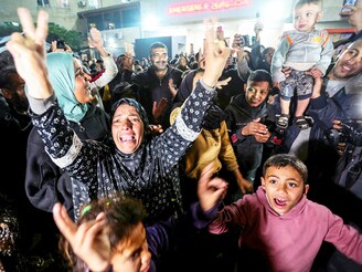 Palestinians react to the news on a ceasefire deal with Israel, in Deir Al-Balah in the central Gaza Strip, January 15, 2025.