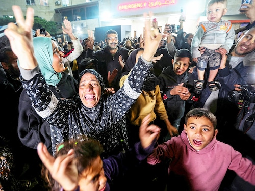 Palestinians react to the news on a ceasefire deal with Israel, in Deir Al-Balah in the central Gaza Strip, January 15, 2025.
