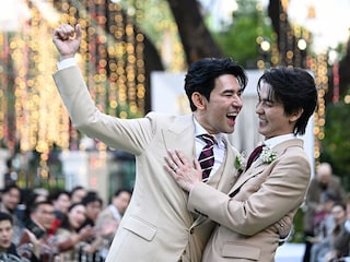 This photo taken on January 10, 2025 shows Apiwat "Porsch" Apiwatsayree (L) and Sappanyoo "Arm" Panatkool posing for photos at their unofficial wedding ceremony in Bangkok.
Image: Lillian Suwanrumpha / AFP©
