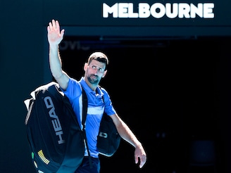 Novak Djokovic of Serbia acknowledges the crowd as he leaves the court after retiring from the Men"s Singles Semifinal against Alexander Zverev of Germany during day 13 of the 2025 Australian Open at Melbourne Park on January 24, 2025, in Melbourne, Australia.