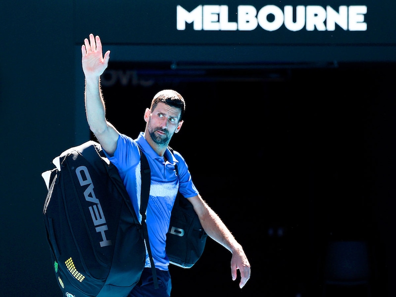Novak Djokovic of Serbia acknowledges the crowd as he leaves the court after retiring from the Men"s Singles Semifinal against Alexander Zverev of Germany during day 13 of the 2025 Australian Open at Melbourne Park on January 24, 2025, in Melbourne, Australia.