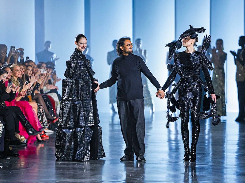 Indian designer Rahul Mishra (C) acknowledges the audience with his models, Canadian supermodel Coco Rocha (L) and US theatre producer Jordan Roth (R), at the end of his presentation during the Women"s Haute-Couture Spring/Summer 2025 Fashion Week in Paris on January 27, 2025.