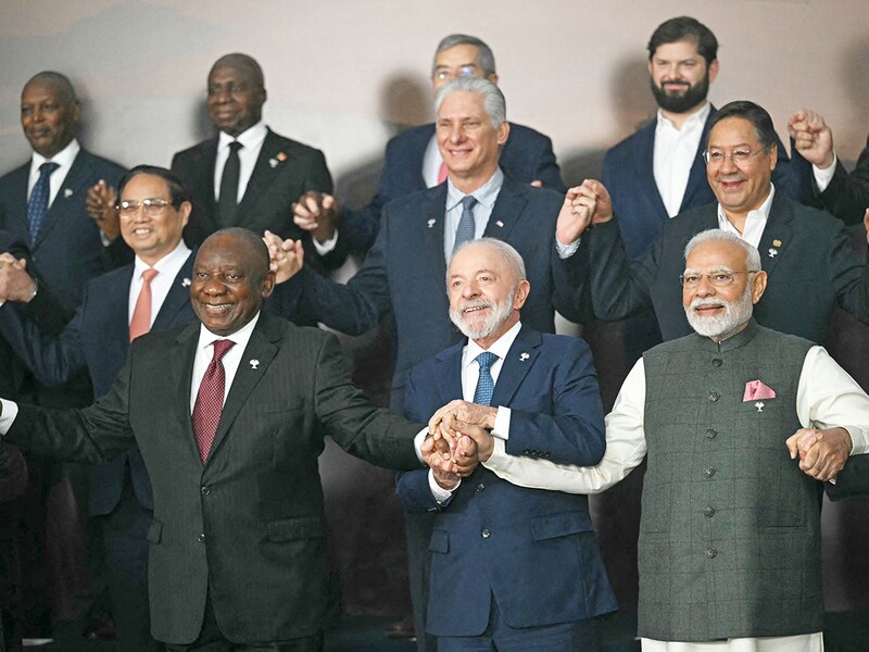 (First row to second row, from left) South Africa"s President Cyril Ramaphosa, Brazil"s President Luiz Inacio Lula da Silva, India"s Prime Minister Narendra Modi, Vietnam"s Prime Minister Pham Minh Chinh, Cuba"s President Miguel Diaz-Canel, and Bolivia"s President Luis Arce Catacora pose for a family photo of heads of state and government of member, partner, and external engagement countries during the BRICS summit in Rio de Janeiro, Brazil, on July 7, 2025. BRICS leaders at a summit on Sunday took aim at US President Donald Trump"s "indiscriminate" import tariffs and recent Israeli-US strikes on Iran.