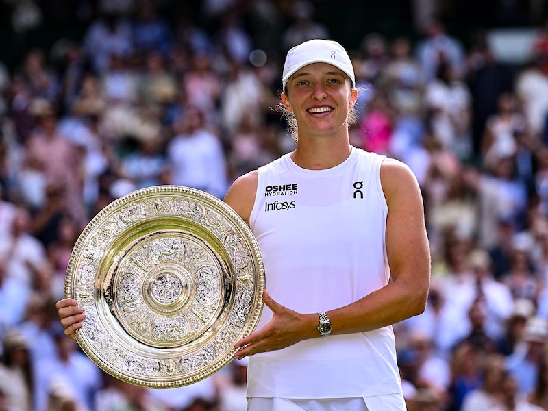 Poland"s Iga Swiatek celebrates with the winner"s trophy, the Venus Rosewater Dish, after winning against US player Amanda Anisimova during their women"s singles final tennis match on the thirteenth day of the 2025 Wimbledon Championships at The All England Lawn Tennis and Croquet Club in Wimbledon, southwest London, on July 12, 2025.