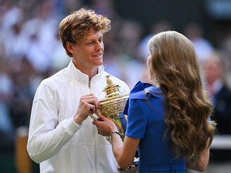 Italy"s Jannik Sinner receives the winner"s trophy from Catherine, Princess of Wales, following his victory against Spain"s Carlos Alcaraz in the men"s singles finals of the 2025 Wimbledon Championships at The All England Lawn Tennis and Croquet Club, London, on July 13, 2025.