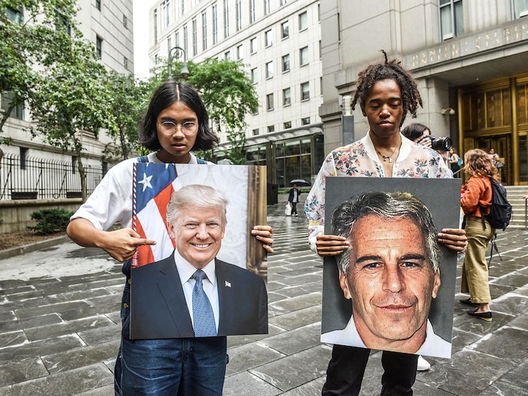 (File) A protest group called "Hot Mess" hold up signs of Jeffrey Epstein and President Donald Trump in front of the Federal courthouse in Juy, 2019 in New York City.  Image: Stephanie Keith / Getty Images North America / Getty Images Via AFP