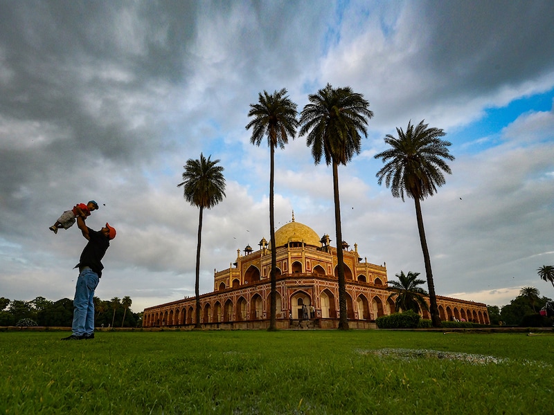 Visitors enjoy a stroll at Humayun"s Tomb in New Delhi after a spell of rain on July 18, 2025 in New Delhi, India. The post-rain atmosphere added to the charm of the historic monument.